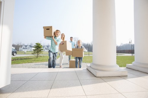Specialist movers wrapping fragile items for safe removal in Richmonduponthames