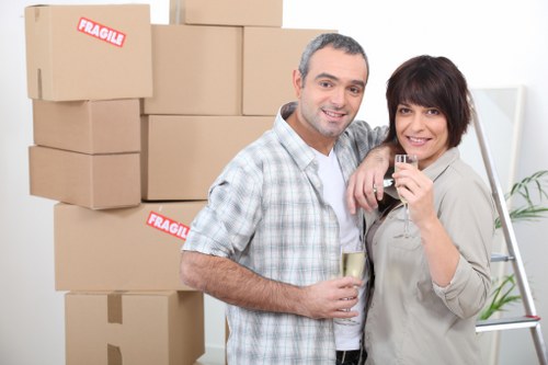 Movers carrying furniture in a South West London home